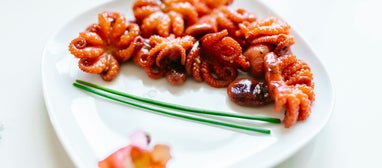 Savor the freshness of tender baby octopus, perfectly seasoned and paired with a tangy, zesty sauce for an unforgettable flavor experience