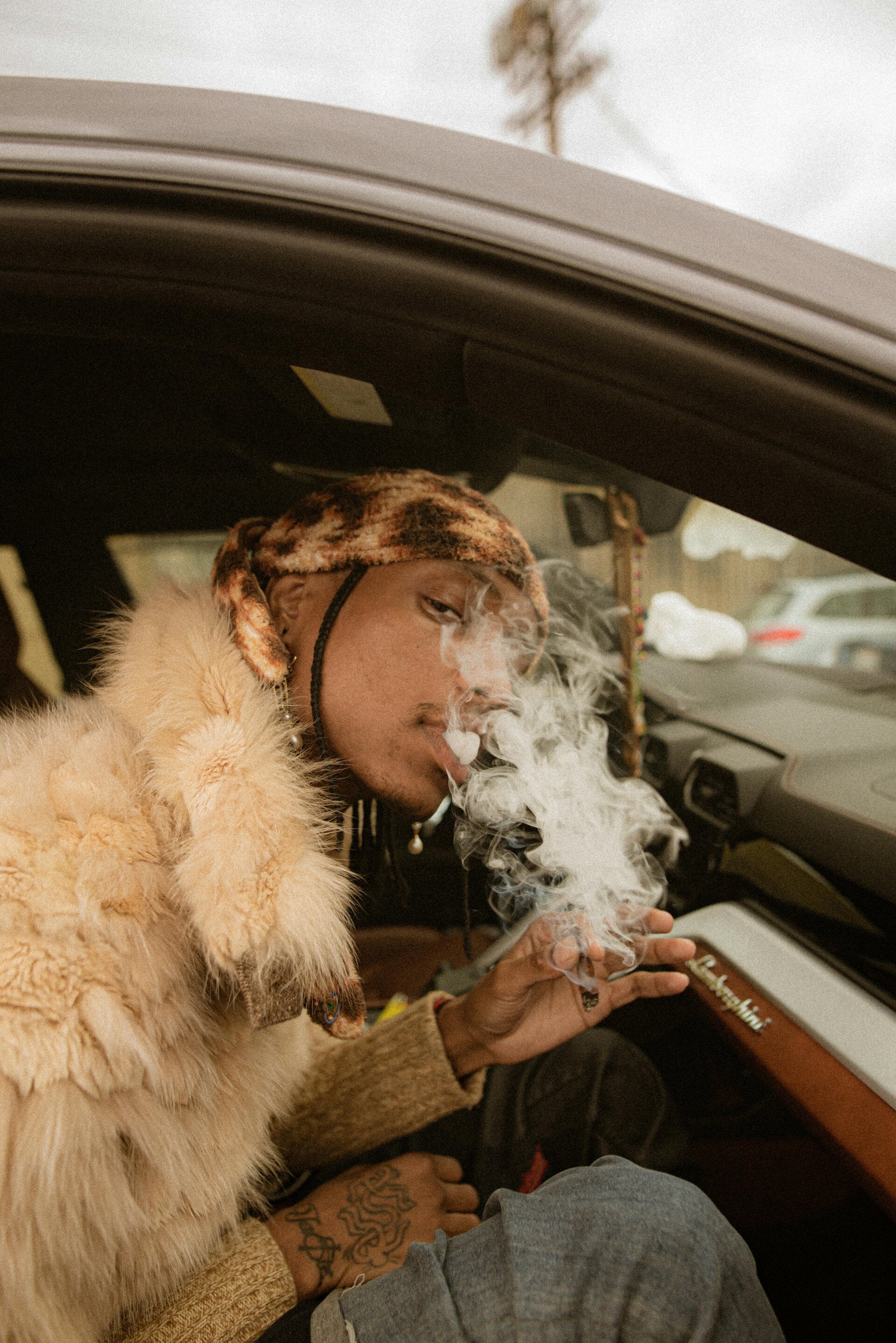 a man smoking a blunt in a car, he needs the Stoner Strategies dosage equation for cannabis edibles, curated by Stoner Strategies using concentrates
