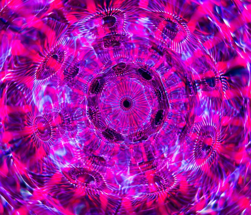 abstract pink, purple and blue kalidescope image, in circural formation, representing AI thinking and creativity