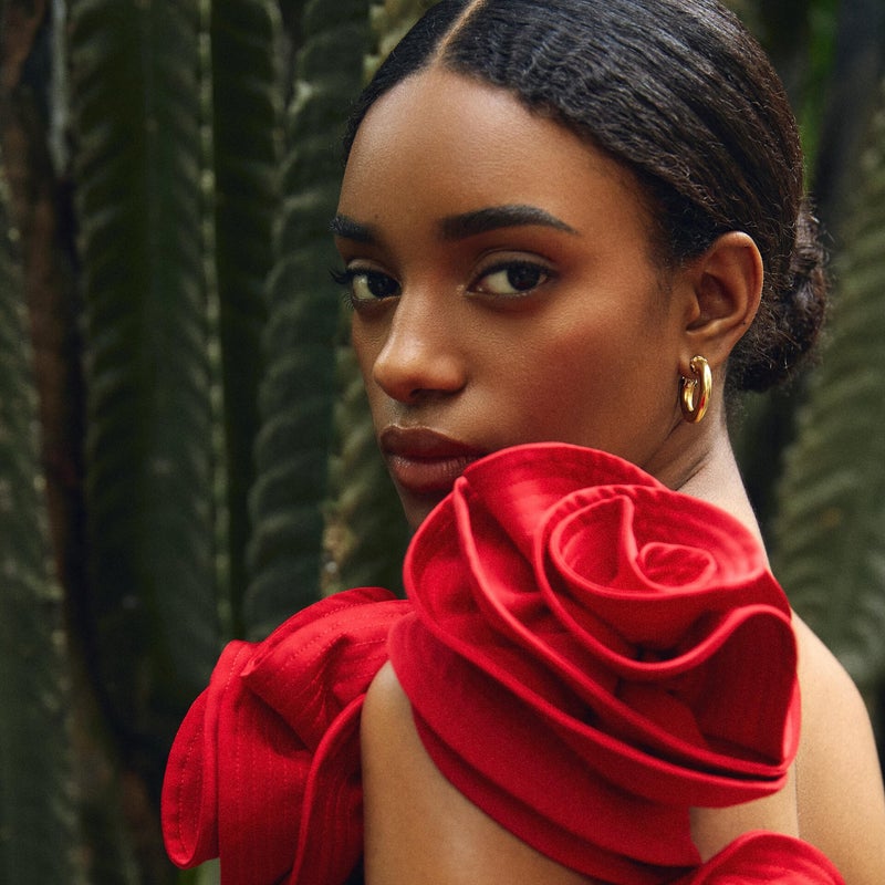 Woman dressed in a beautiful floral rose dress, embodying the spirit of Moroccan festivals and traditions.