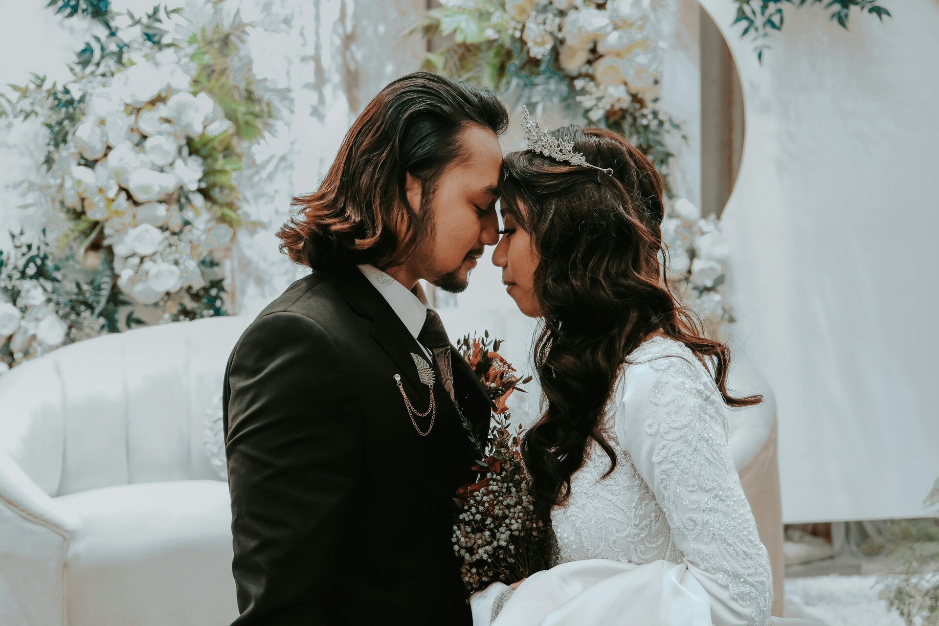 Intimate winter wedding ceremony in New York with couple exchanging vows near a rustic fireplace and glowing candles.
