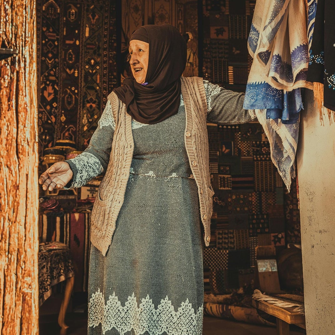 Traditionally dressed Moroccan woman on a train journey – capturing the essence of local and authentic travel in Morocco