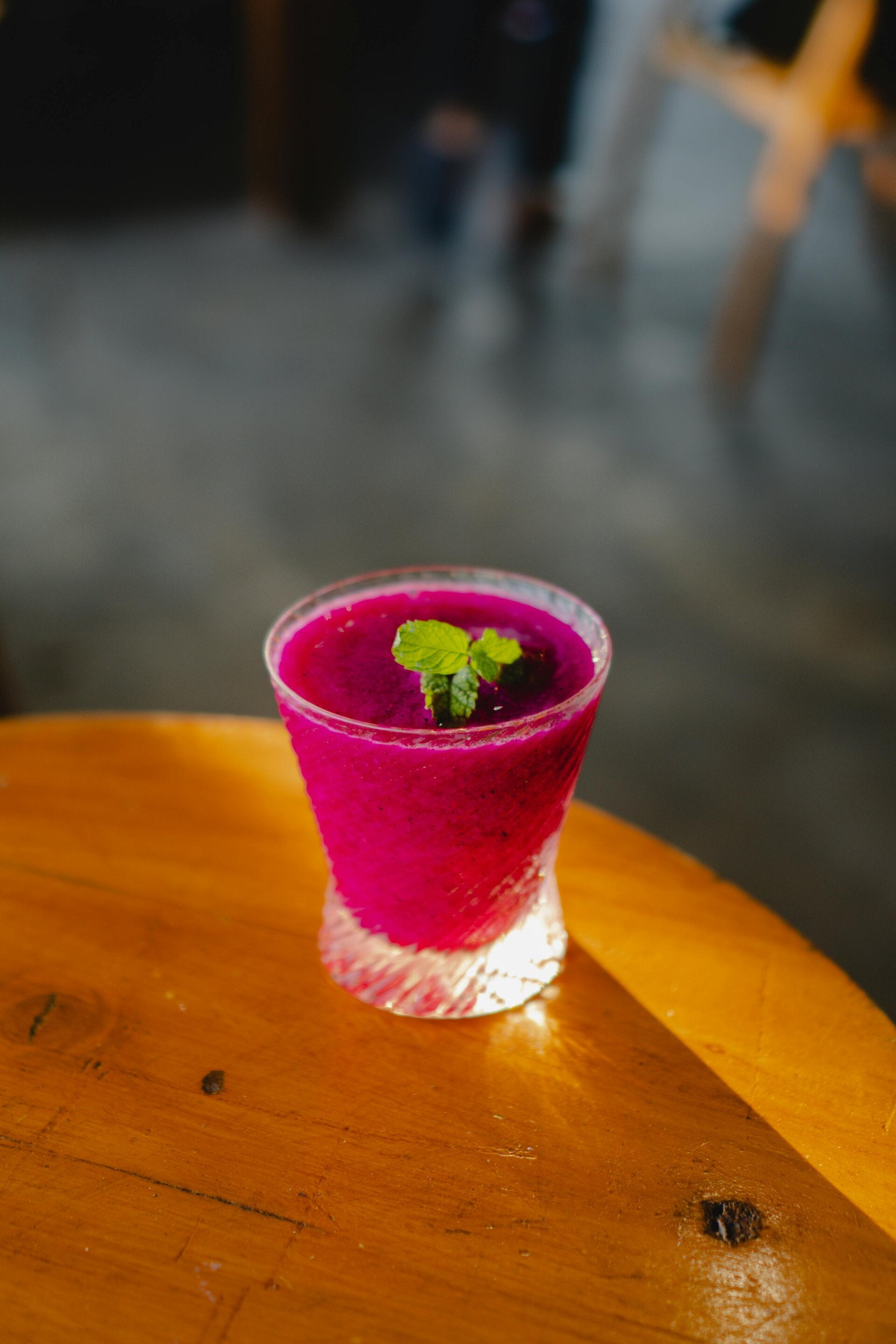 A cup of vibrant, smooth purple beetroot dip garnished with fresh herbs 