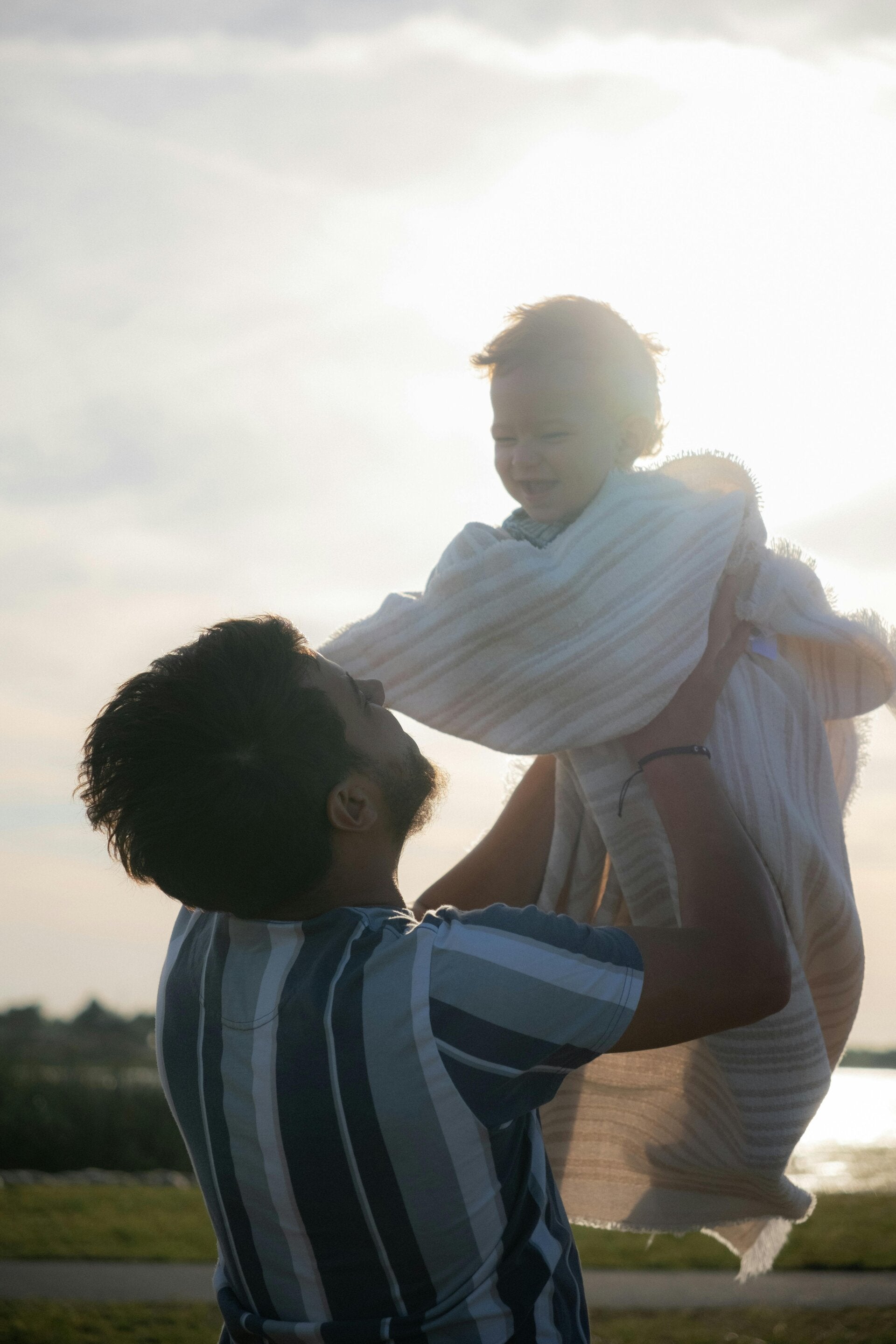 Father holding child protectively, symbolizing family protection and legacy.