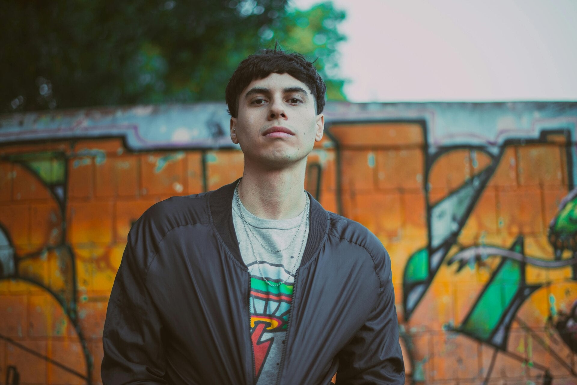 A confident teenage boy walking in a London urban setting, representing the resilience and focus of young men aged 15-18 in West London.
