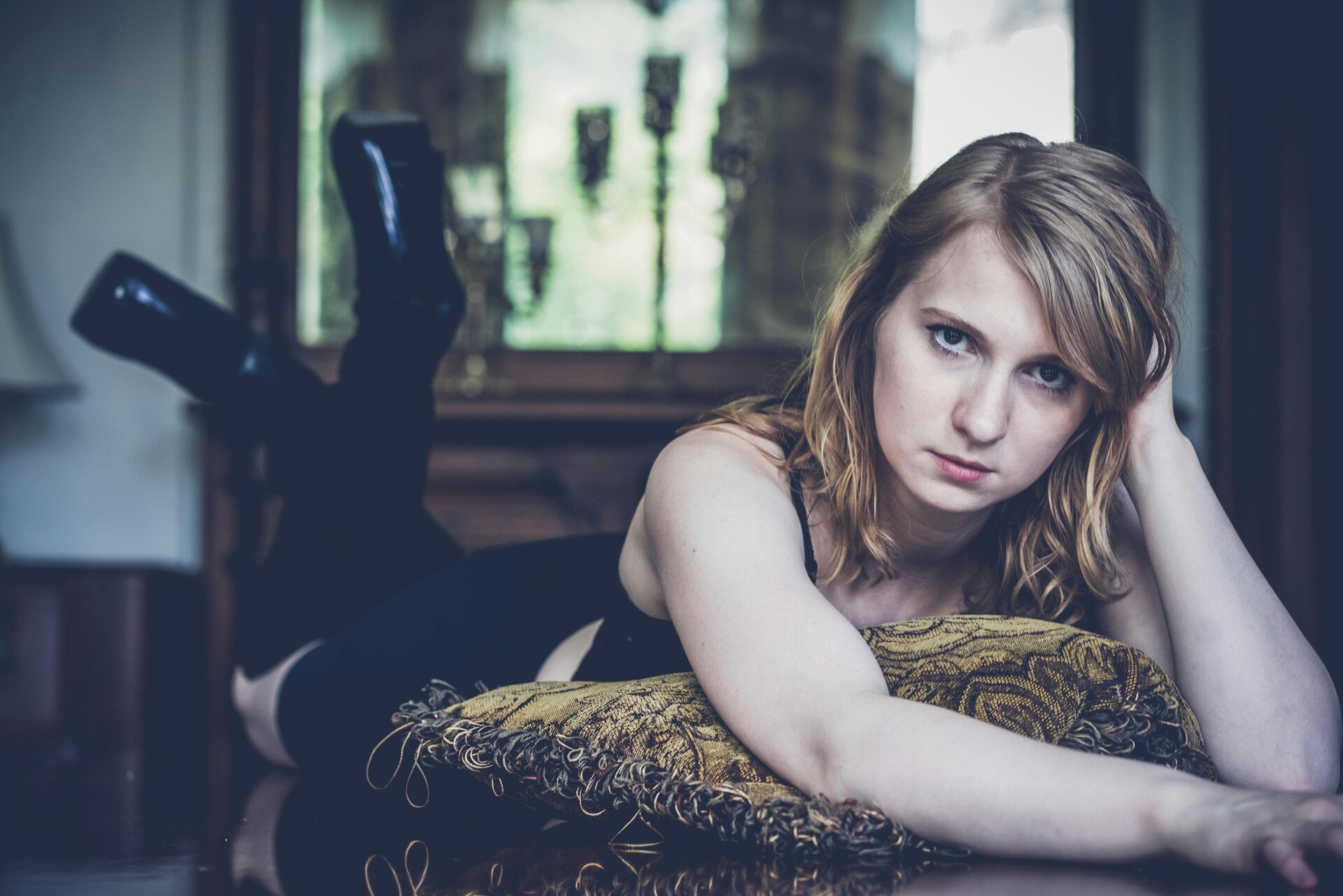 Low desire - a woman lays on her front with a disinterested expression