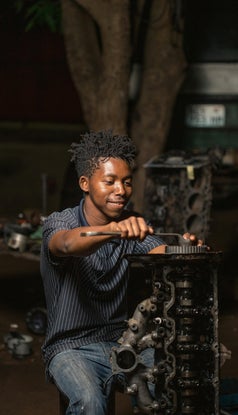 A skilled artisan carefully crafting a leather project, showcasing the precision and artistry of handmade leatherwork.