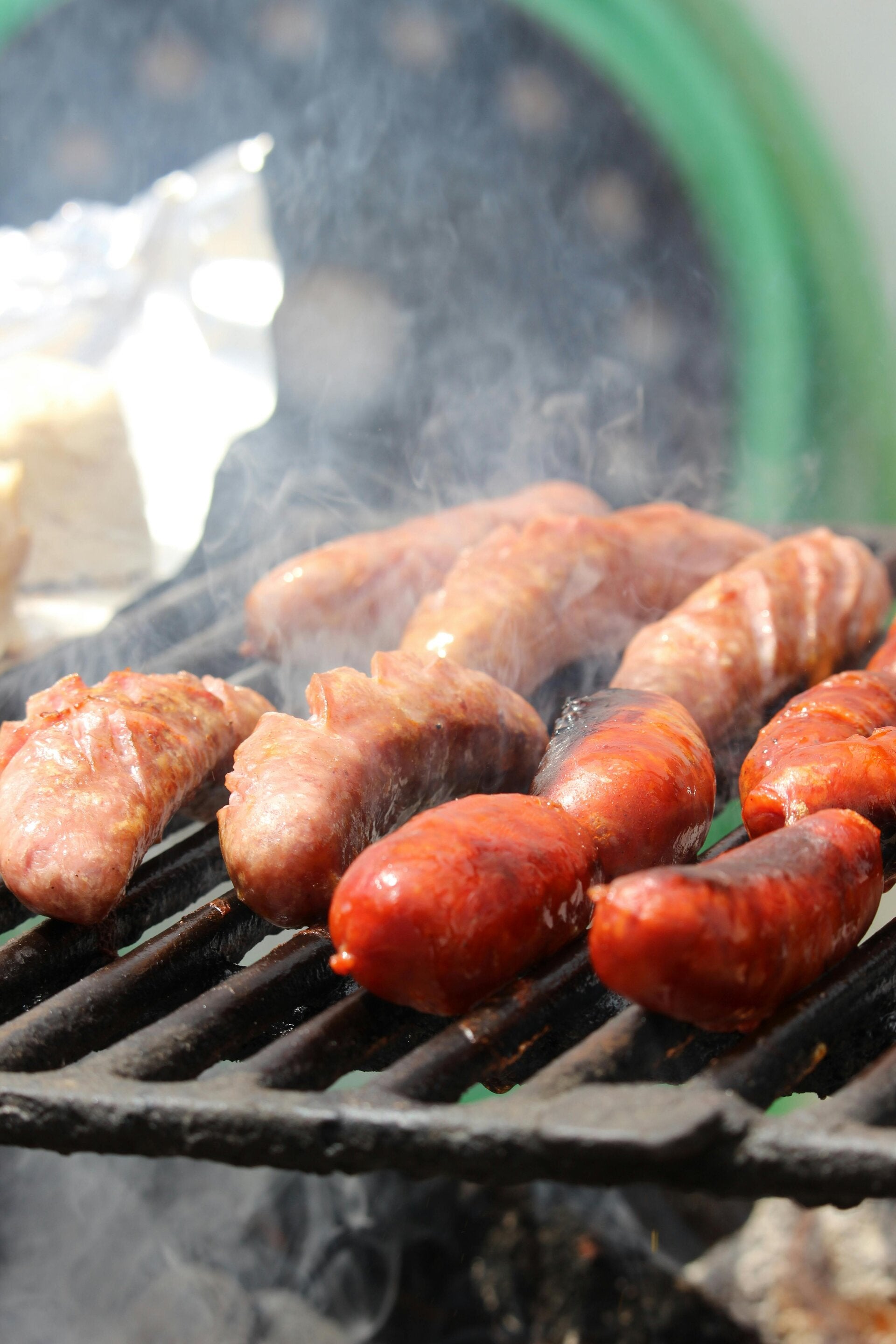 bunch osf sausages grilling.