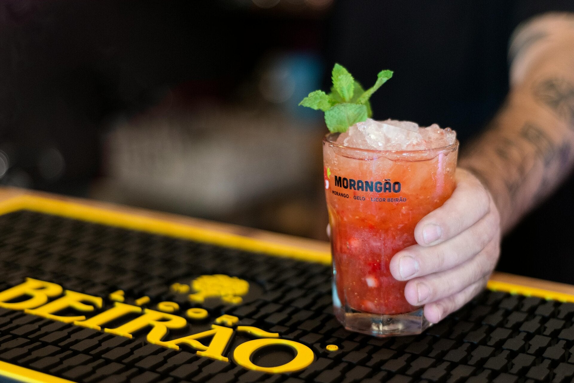 A chilled Cannabis Strawberry Mint Martini garnished with fresh berries and mint, a perfect choice for cannabis edibles and Stoner Strategies fans