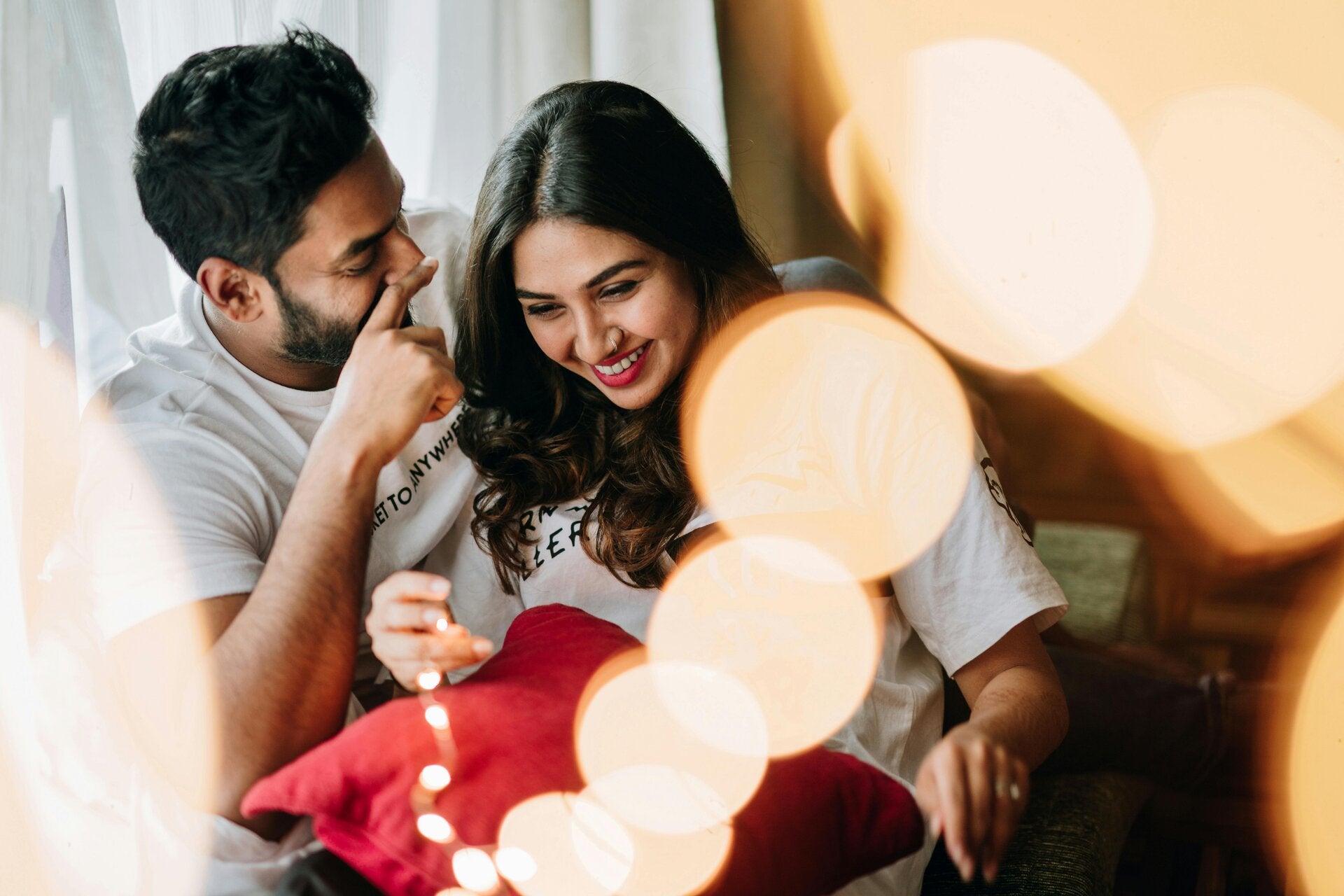 couple enjoying a romantic evenening together sitting on a sofa in a living room