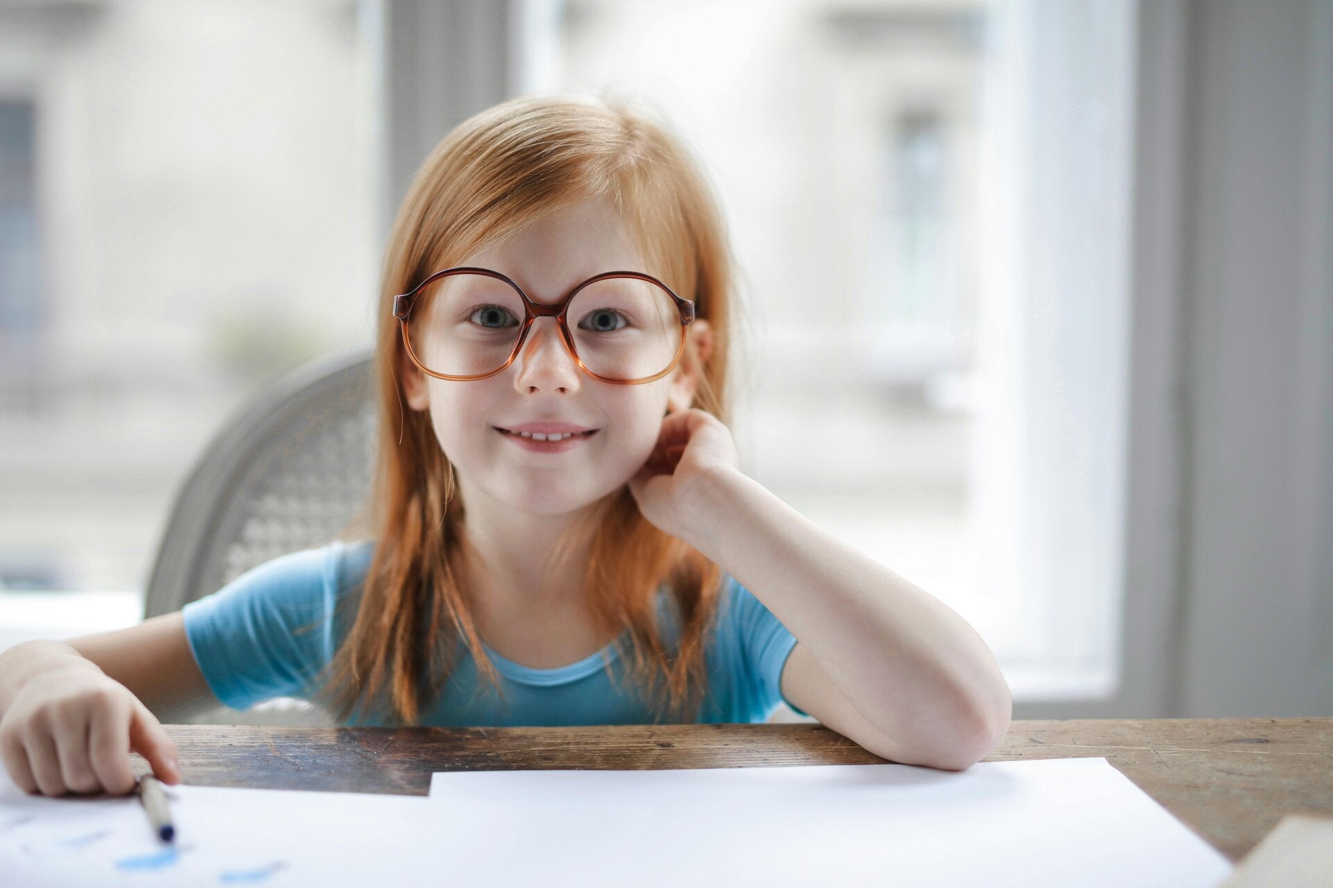 smiling girl with a paper and pencil