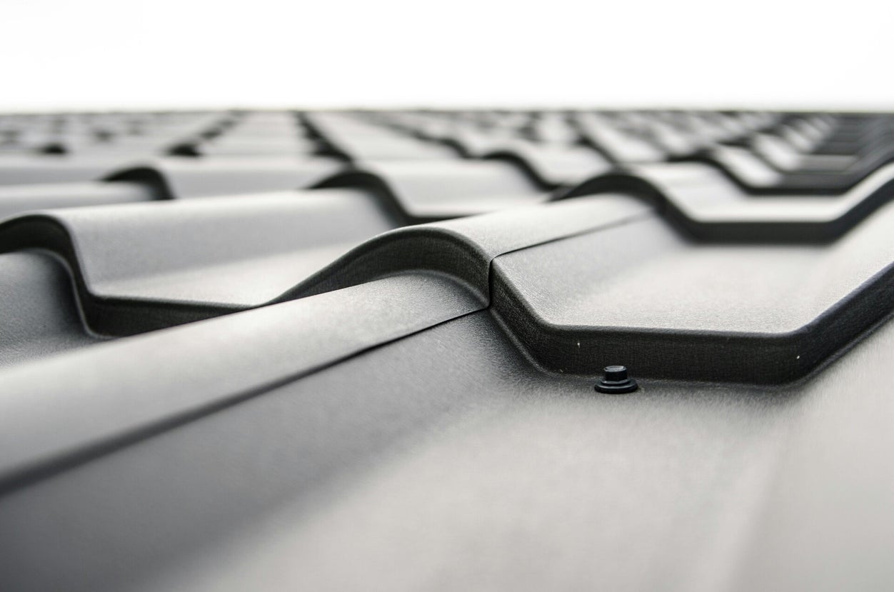 Different roofing materials used on Virginia homes including shingles and metal roofing