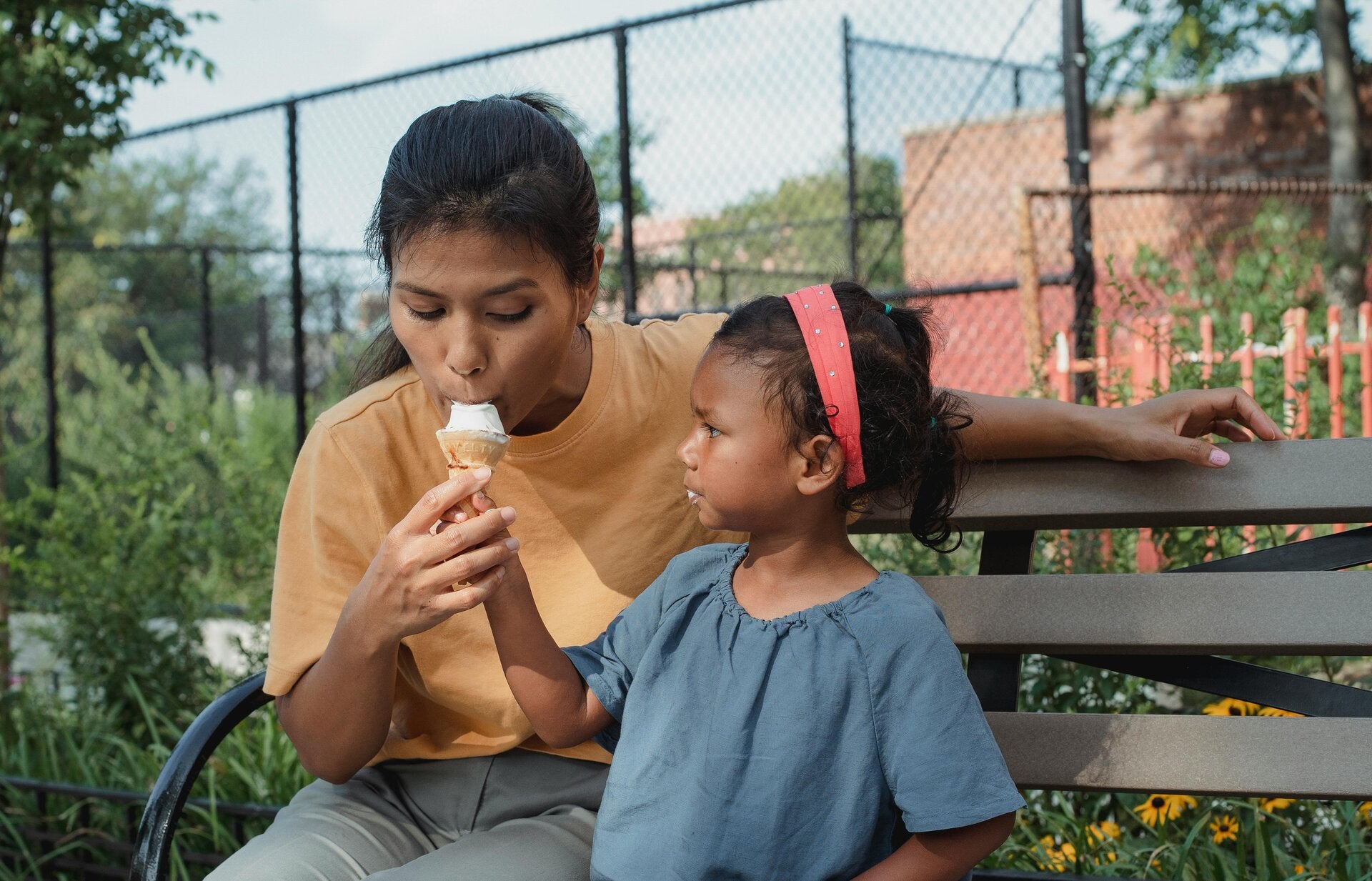 parent and child sharing ice cream together