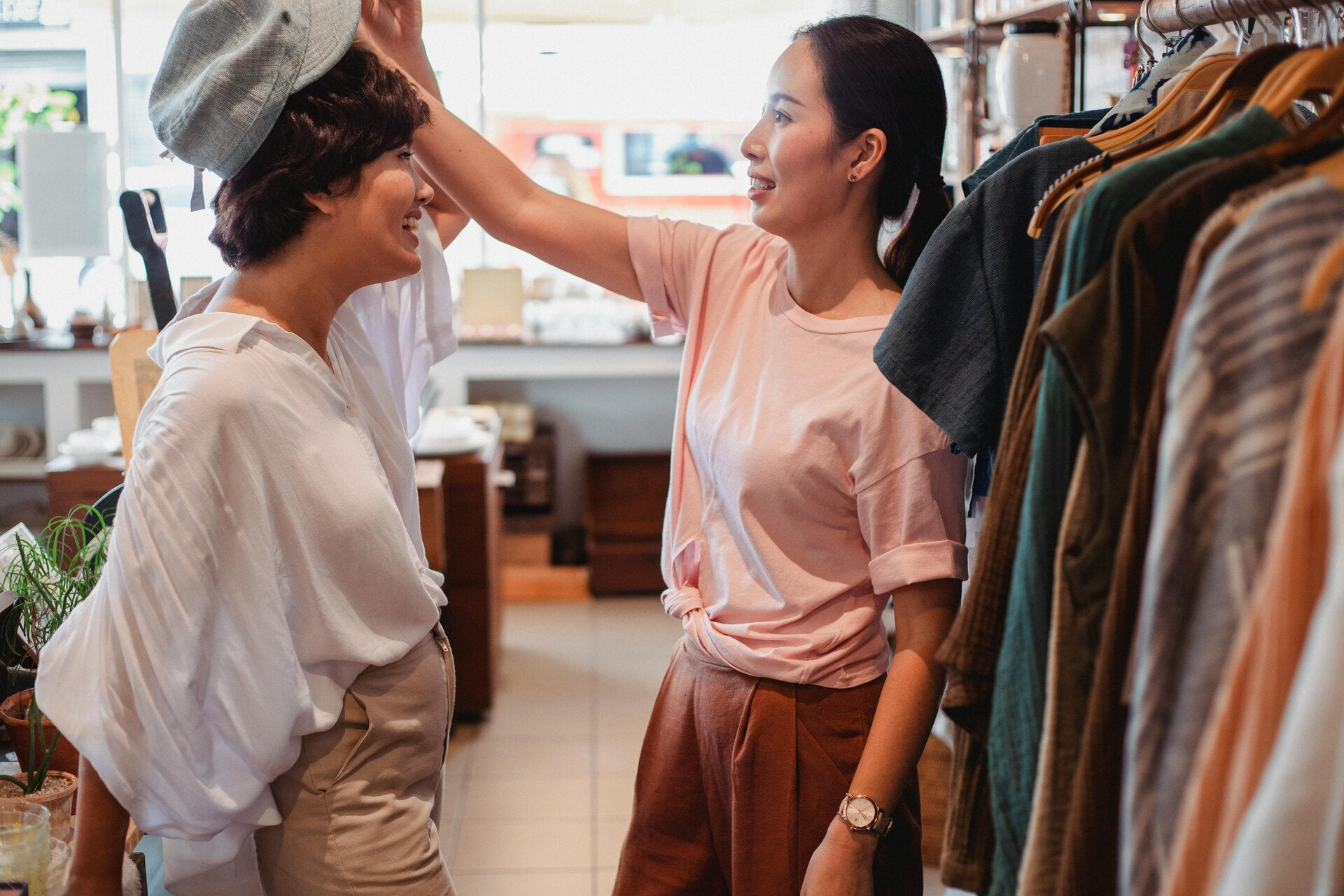 Customers trying on hats in the shop[