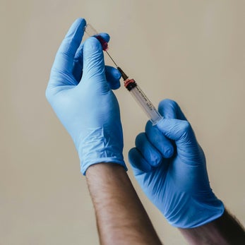 Healthcare professional preparing injection therapy treatment