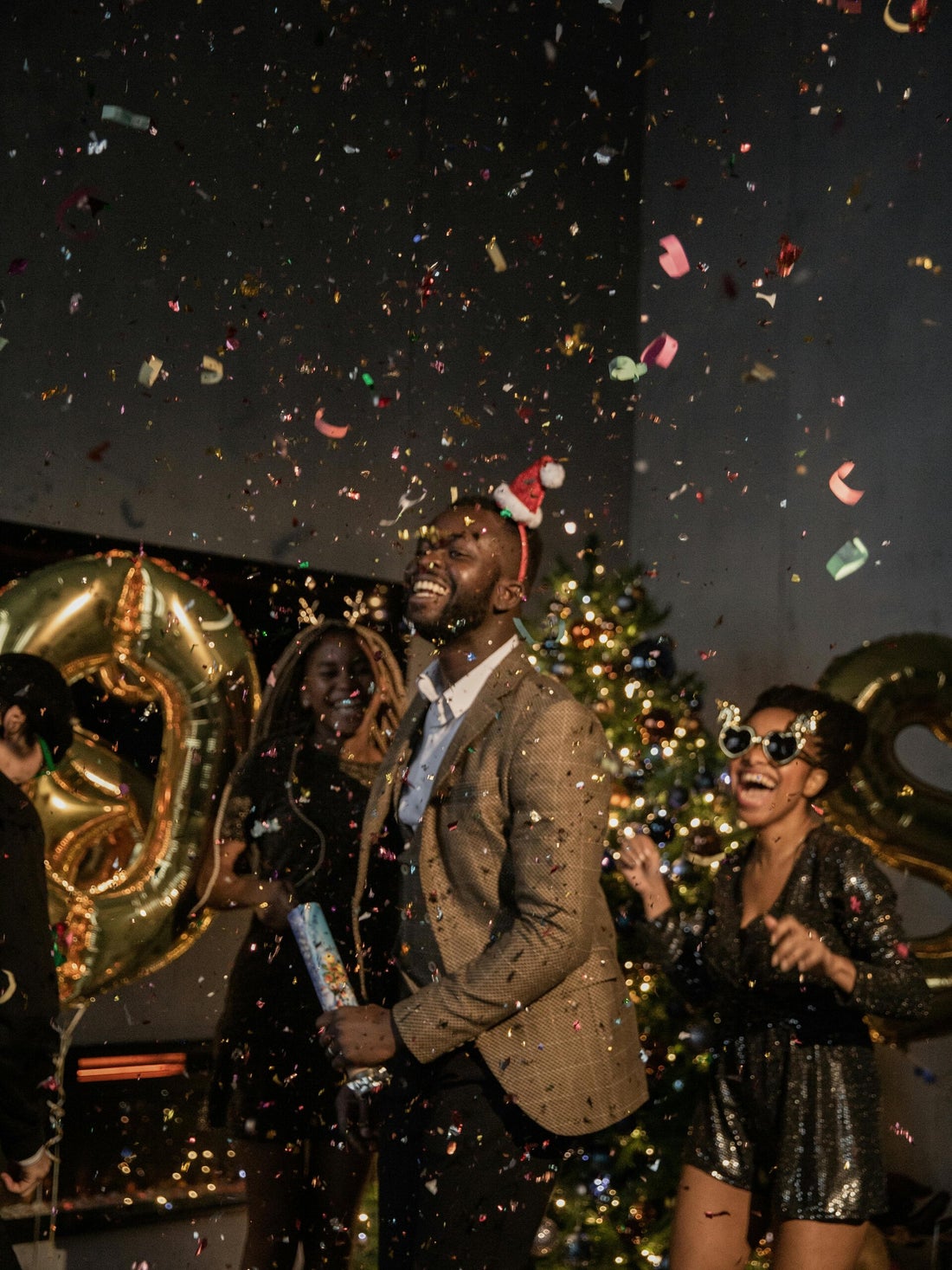 Guests celebrating beneath confetti at a festive party