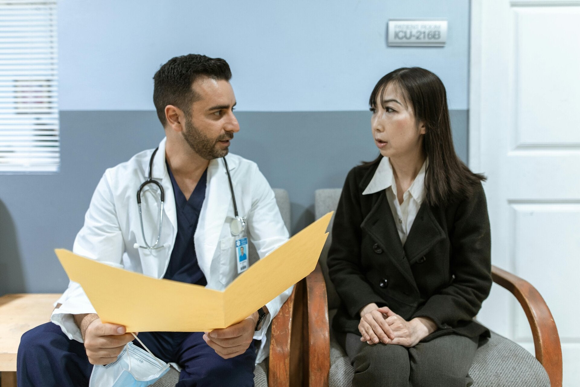 Doctor talking with a asiatic woman patient about a document