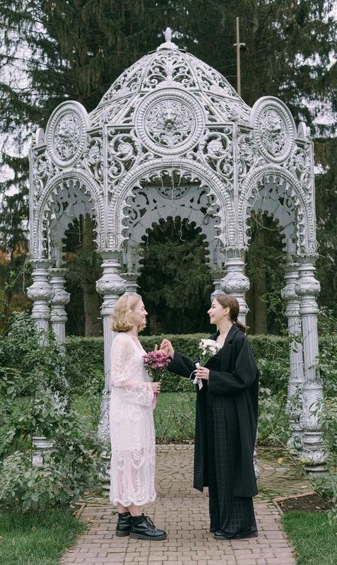 Couple exchanging vows in a Hudson Valley garden wedding surrounded by flowers