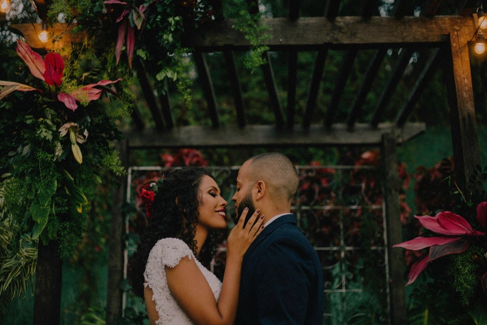 Bride and groom embracing under a decorated arch during a rustic Hudson Valley vow renewal