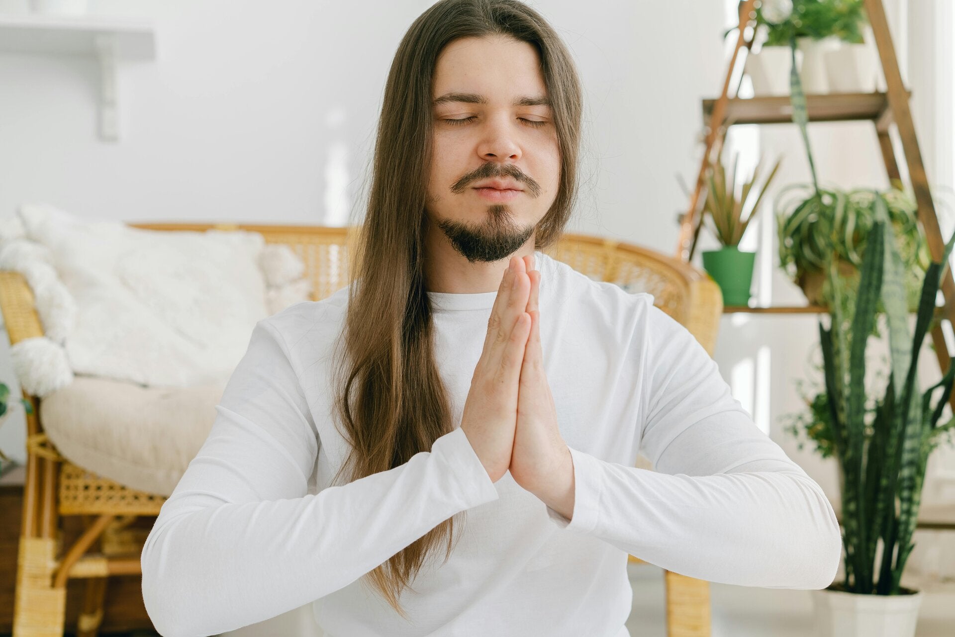 Wat is mindfulness? Man mediteert in woonkamer - Fayana Healing blog