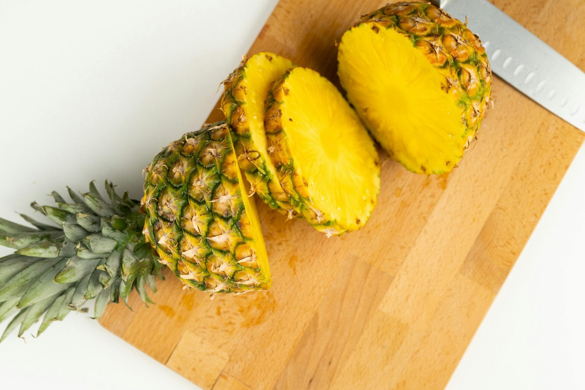 Sliced pineapple on a cutting board getting prepped for making cannabis pineapple salsa