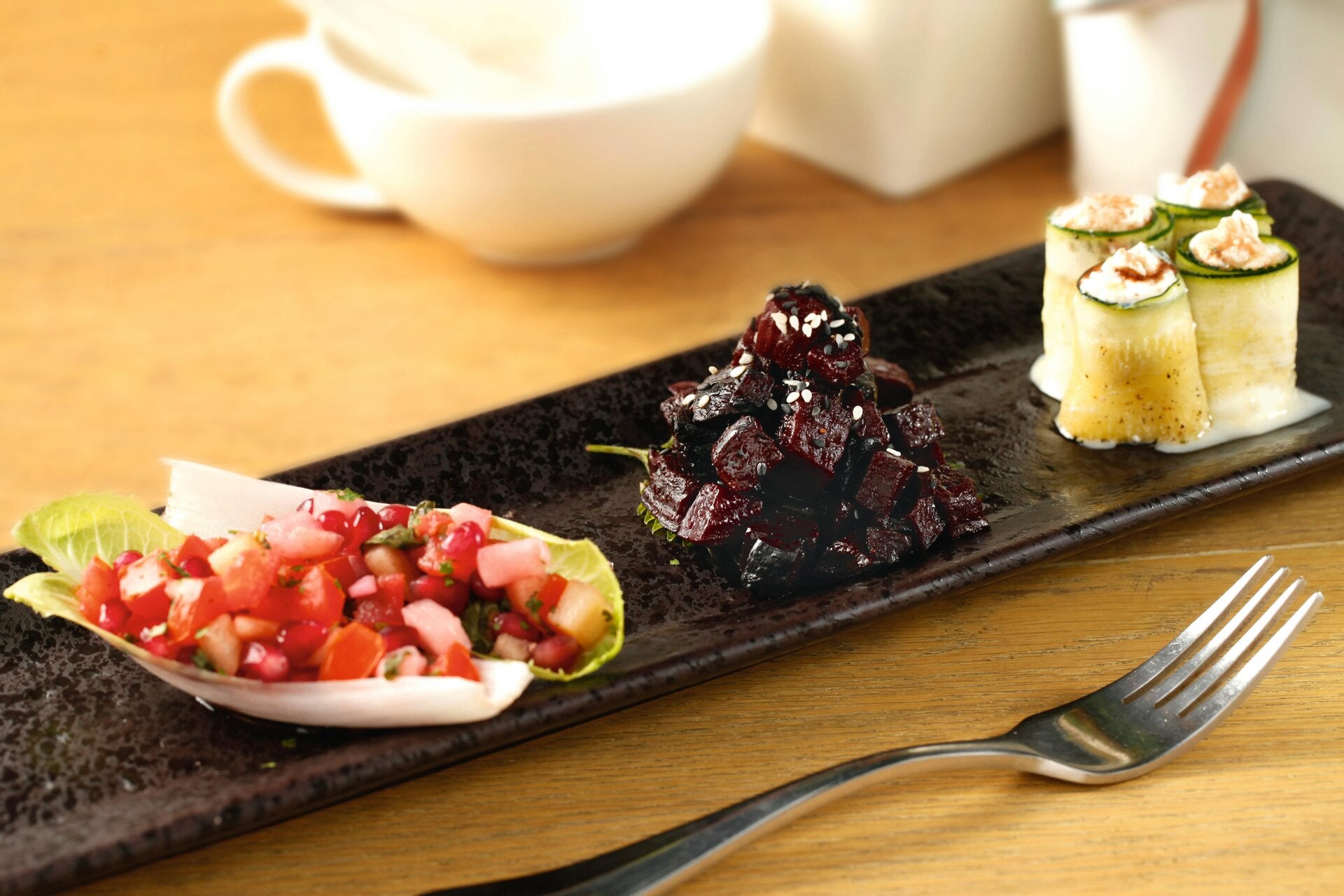 a prolongated plate with Beets/Salsa/Cucumber Rolls