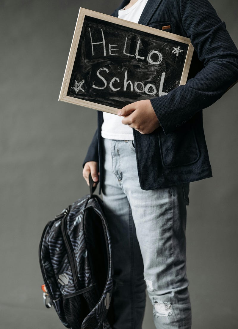 Student holding a Hello School sign