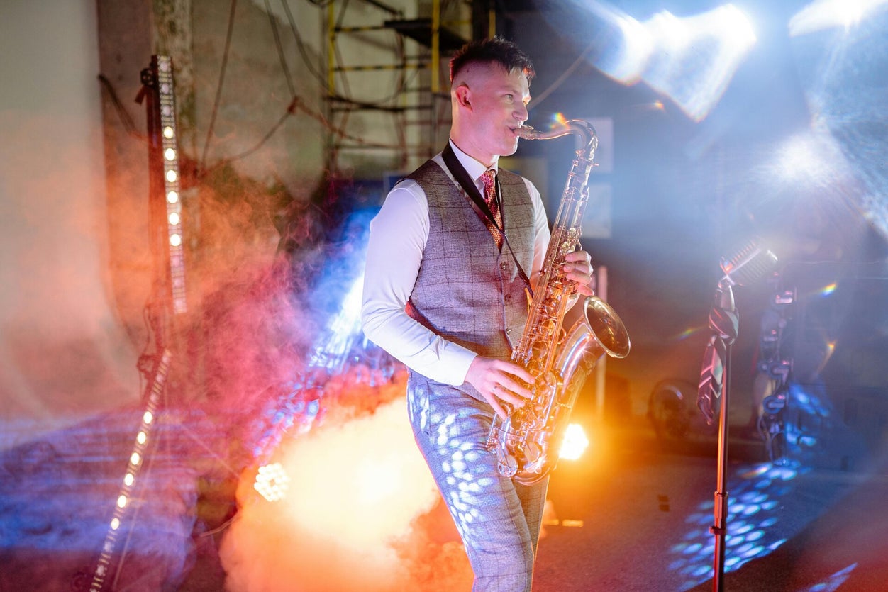 Live saxophonist performing as an optional musician alongside a wedding DJ