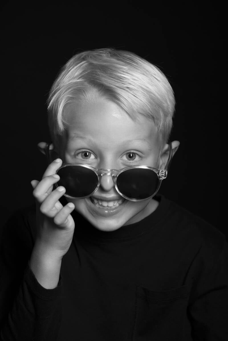 Say Cheese! Een low key foto gemaakt in de fotostudio met een zwarte achtergrond. Johan Bouwmans Fotografie uit Deurne werkt graag met kinderen. Dit kan buiten in de natuur of in mijn fotostudio