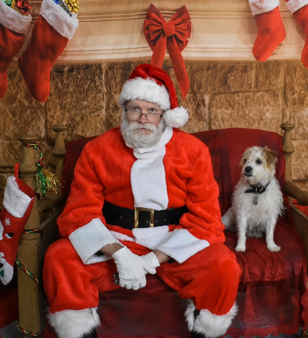 Santa David by the fireplace for a Christmas home visit in London, Ontario