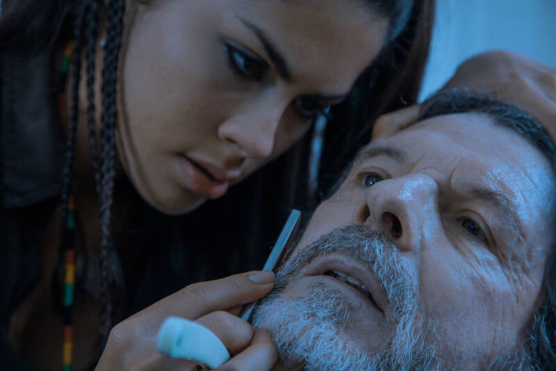 Close two-shot of two actors in a cool blue colour grade