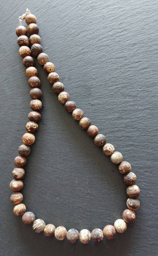 Bruine snake skin agaat met zilveren lobstersluiting