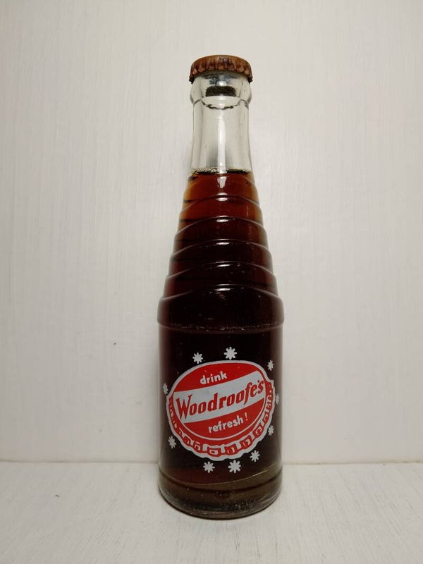 Vintage 1969's Woodroof's bottle with contents.