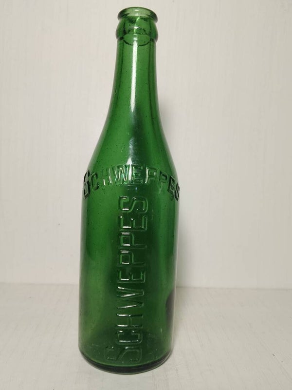 Green Schweppes 13 Oz crown sealed bottle.