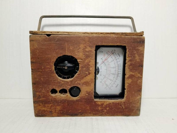 Vintage analogue multimeter in a bespoked wooden box.