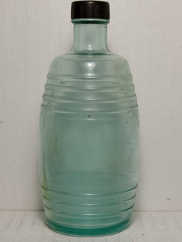 Wine barrel shaped small aqua blue bottle.