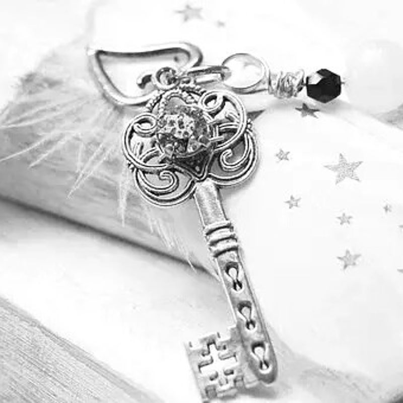 Sleutel op een veer en sterretjes staat voor Afspraak Coaching de Reflectie Hamont