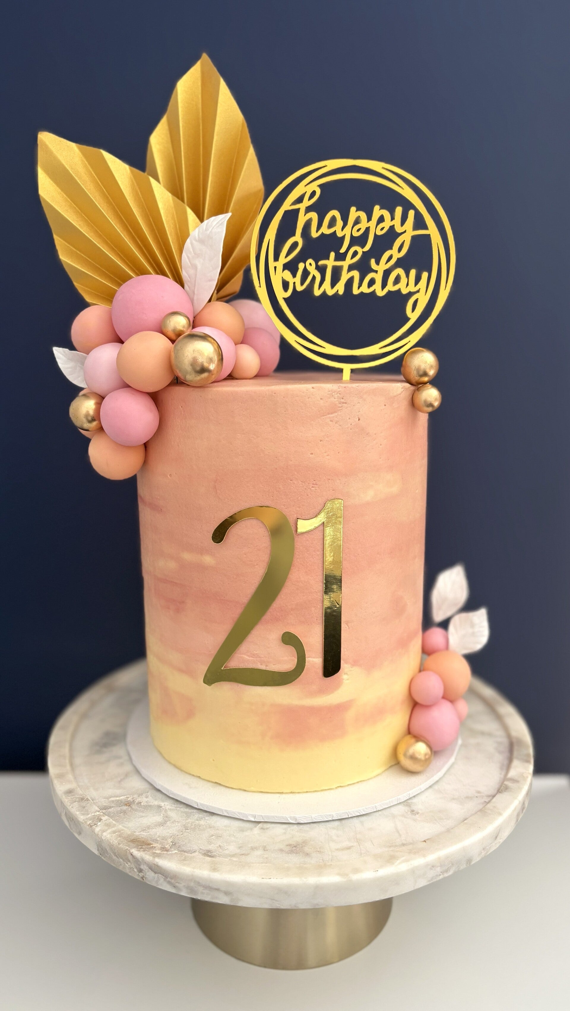 Anniversary cake decorated with pastel coloured buttercream flowers & a written message.