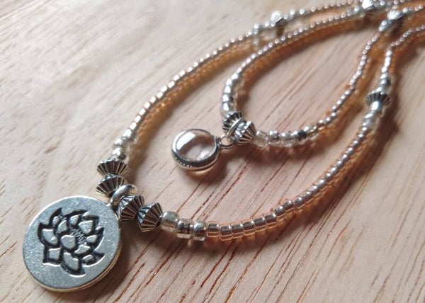 Collier de perles fleur de lotus beige lumineux