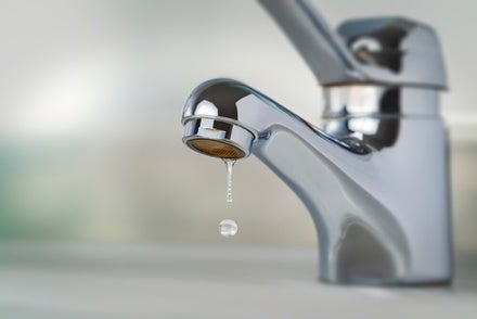 Detail van een lekkende kraan met druppel water, typisch probleem met kraanwerk
