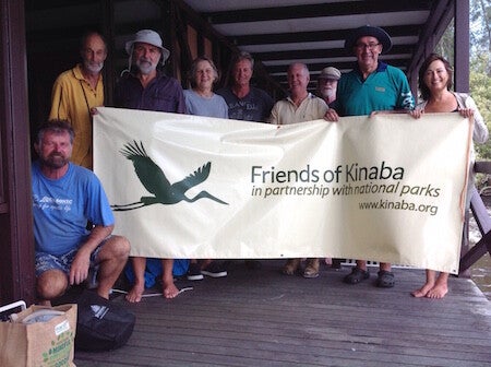 Volunteers holding the Friends of Kinaba banner