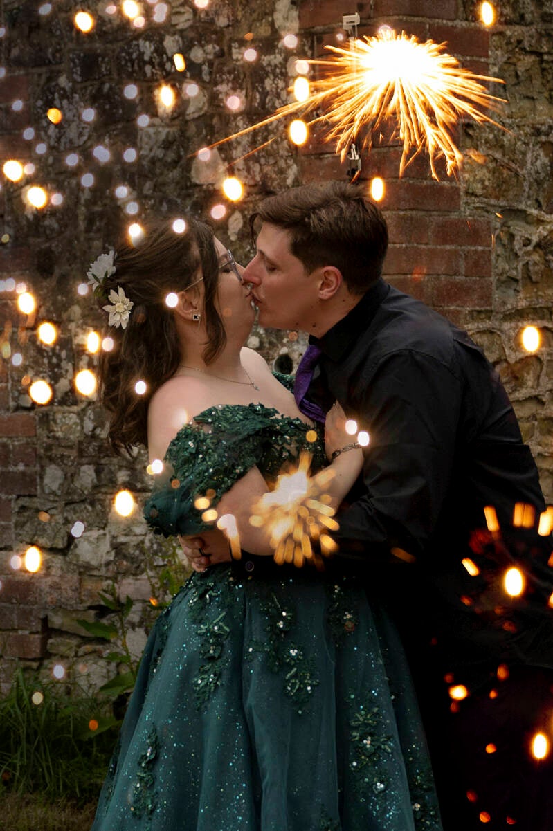 couple kissing with sparklers
