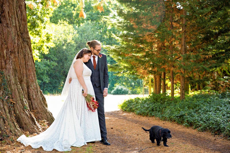 couple portrait with their dog in the woods