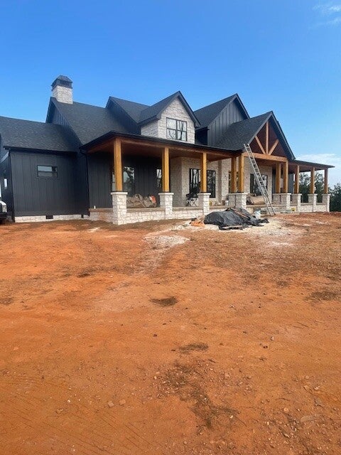 6 inch black seamless gutters with 4 inch round downspouts on beautiful custom built home 
