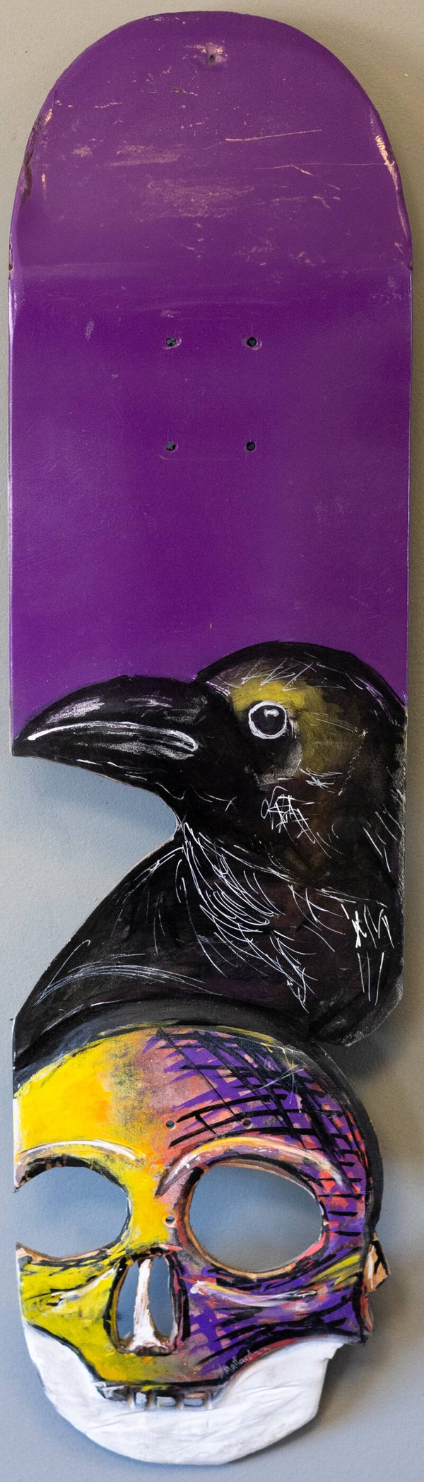 skateboard of crow on abstract skull