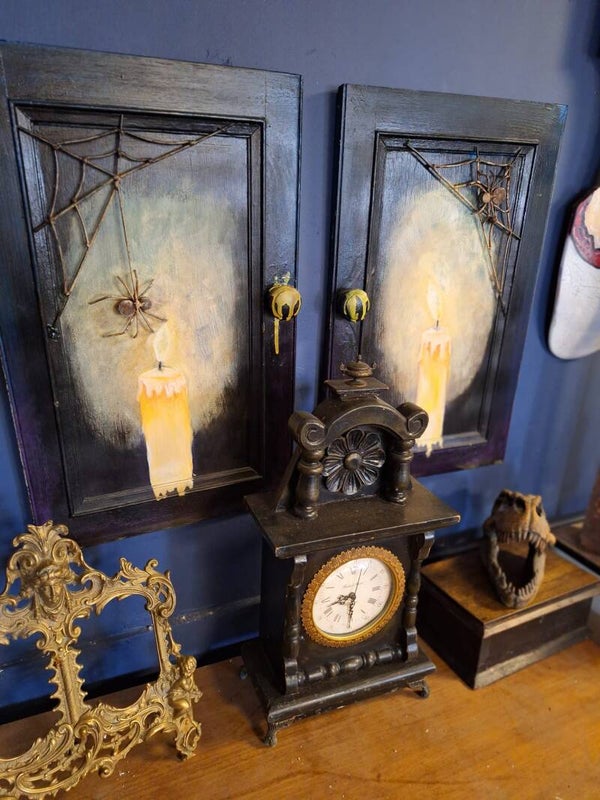 Candle on canvas with metal spider