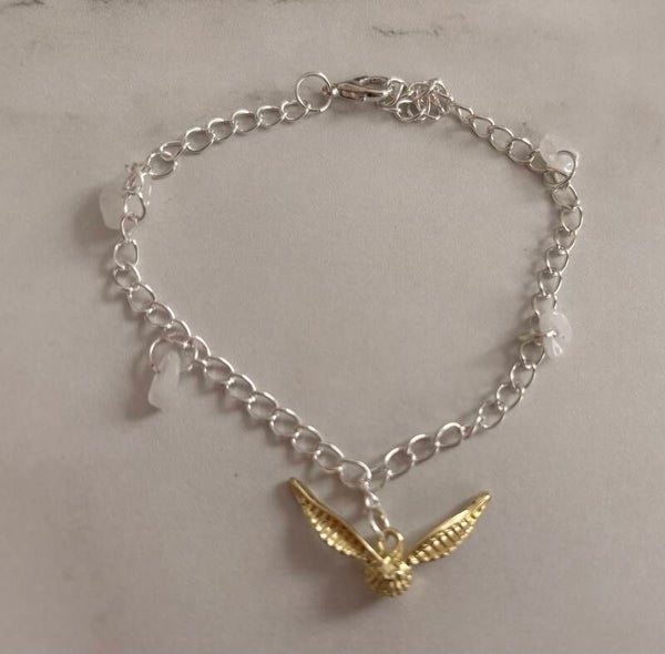 Bracelet en acier inoxydable – Ailes dorées & pierres translucides
