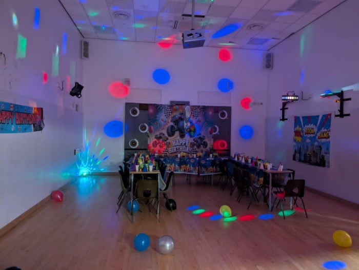 The AME party room decorated with balloons and lights