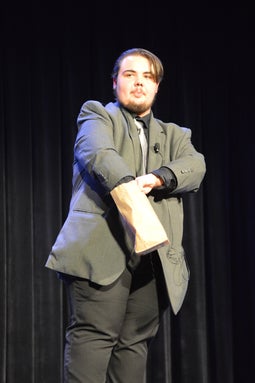 Sam performs magic on stage in Greensboro, North Carolina.