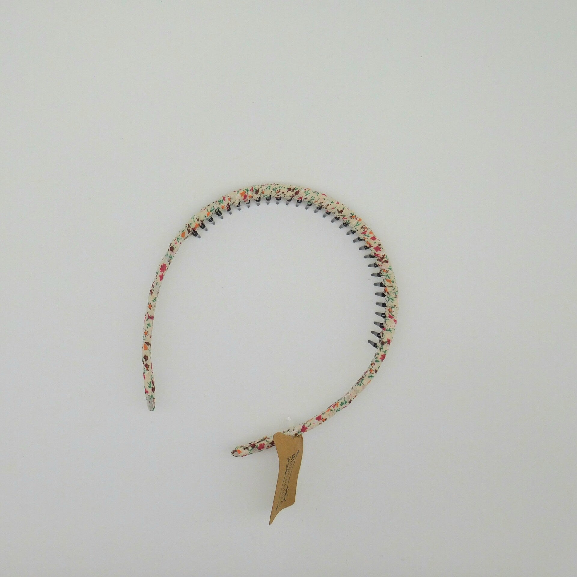 Diadeem stof met tandjes bloemetjesmotief roze/wit